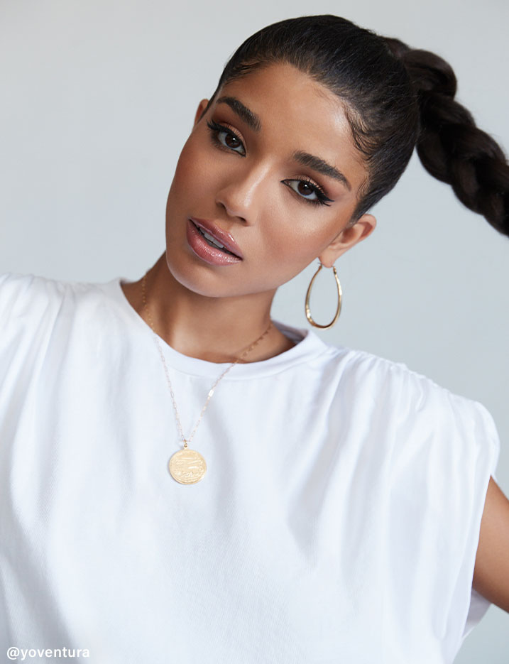 A closeup of Yovanna Ventura with her hair slicked back and bronzed makeup. Shop Get the Glow.