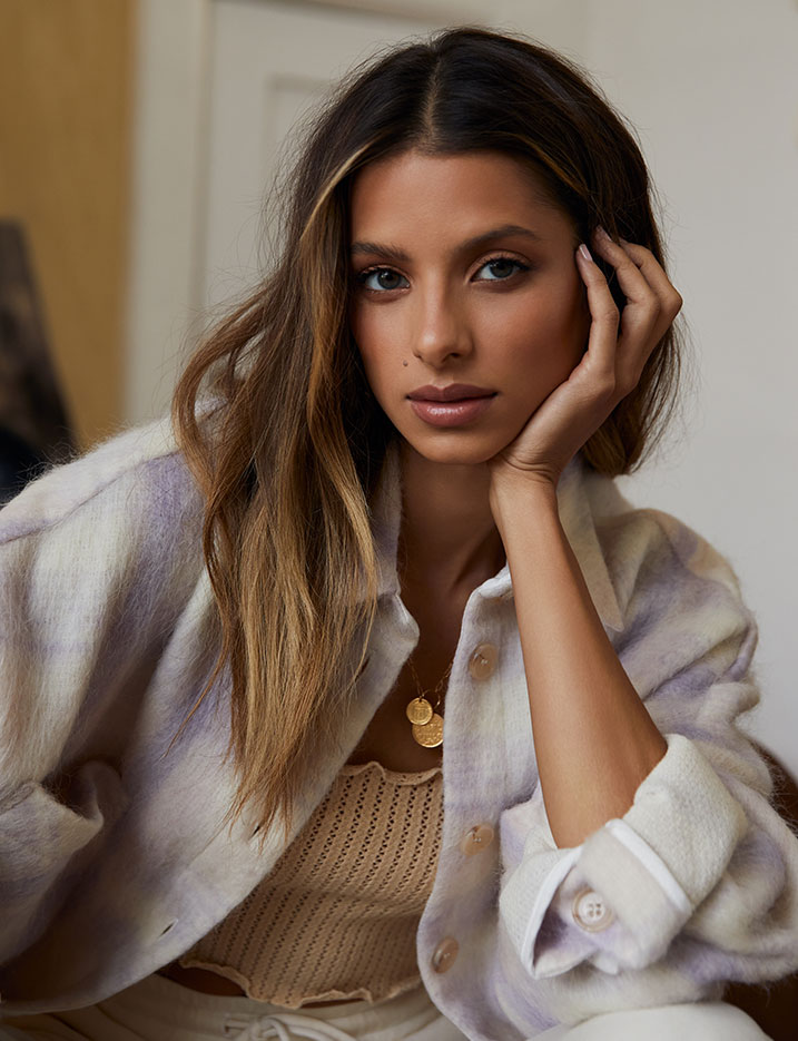 Nighttime beauty and sleep essentials arranged on a silk sheet. Shop Sweet Dreams.
