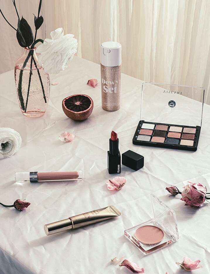 A variety of make up laid out on a table cloth. Fresh Faced Makeup