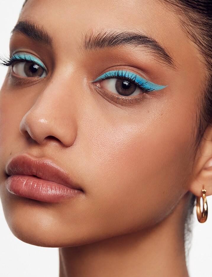 Model with soft teal cat eye liner.