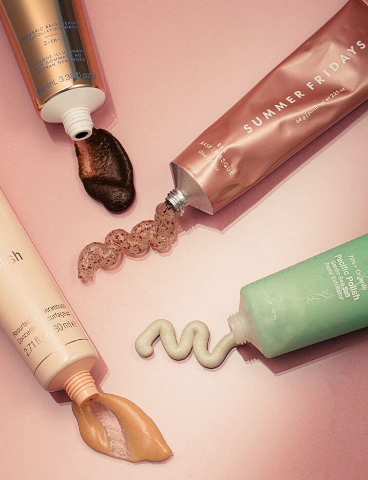 A colorful variety of skincare product tubes squeeze out samples of exfoliating cleansers and scrubs.