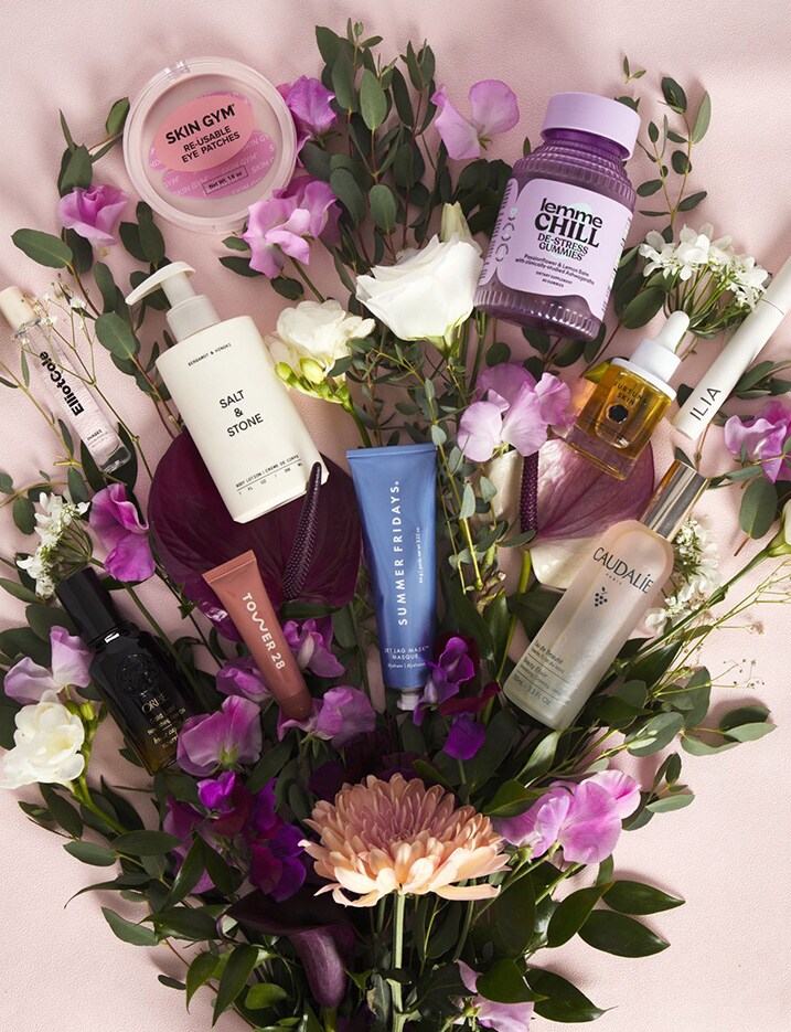 Assortment of beauty products combined with a bouquet.