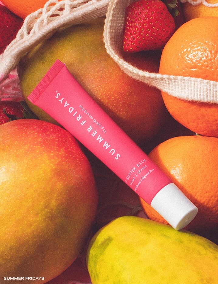 Summer Fridays Lip Butter Balm on top of a bag of fruits.