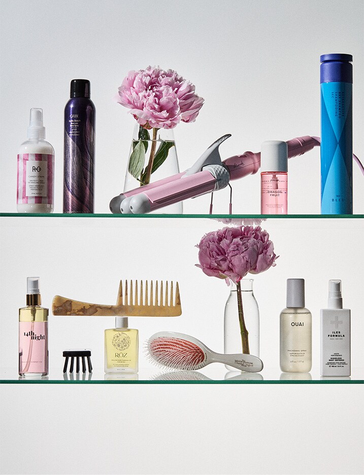 Variety of beauty hair products on glass shelf.