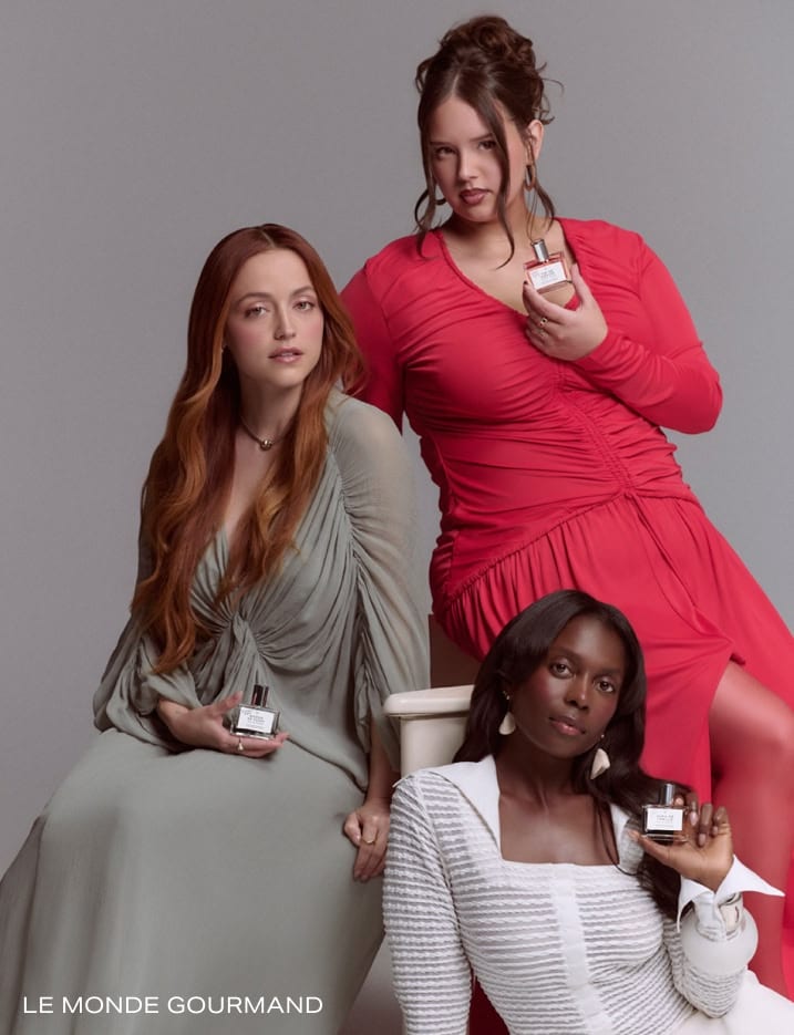 Models holding Le Monde Gourmand fragrance.