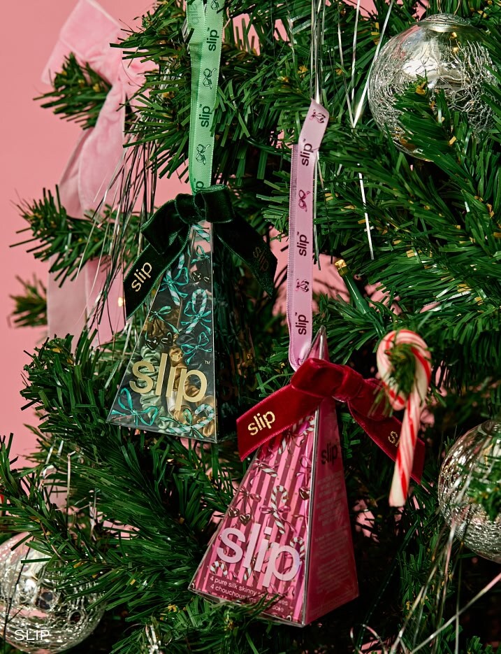 Slip Christmas ornaments hanging on a Christmas tree.