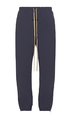 Fear of God ESSENTIALS Military Nylon Trackpant in Marine | REVOLVE