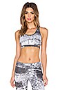 view 1 of 4 Cut Out Racerback Sports Bra in Abstract Print