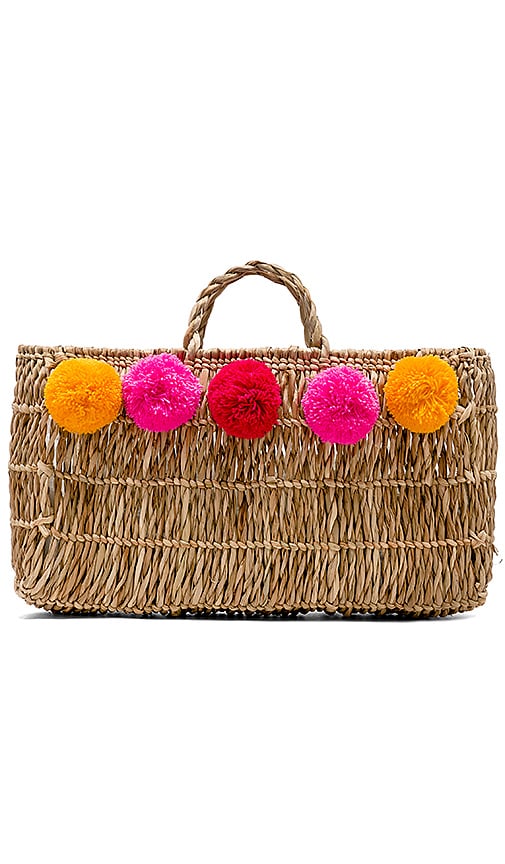 straw tote with pom poms