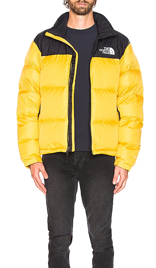 yellow and black north face puffer
