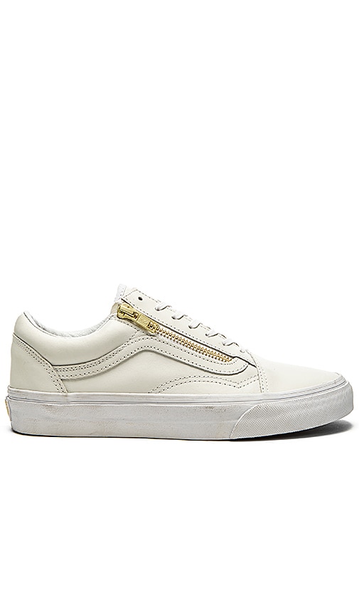 white sneakers with gold zipper