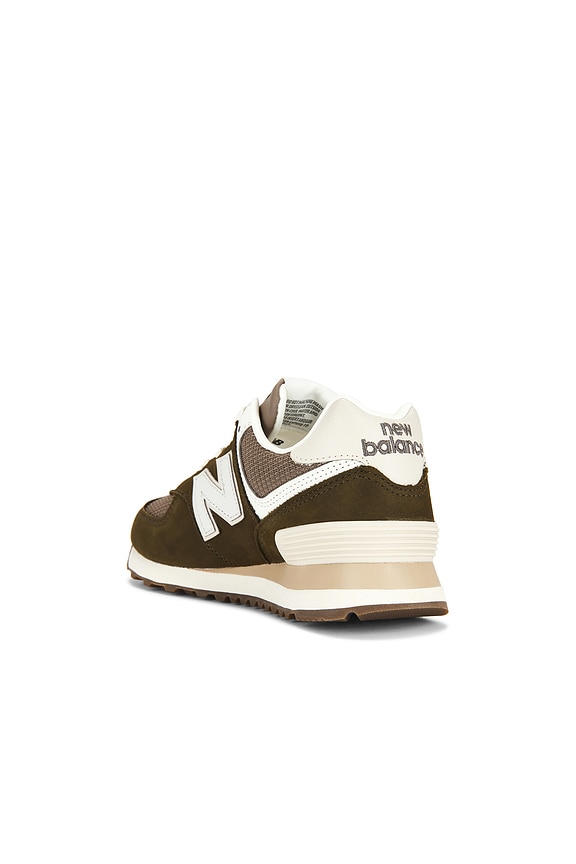 New Balance 574 Sneaker in Calcium & Dark Silver Metallic | REVOLVE