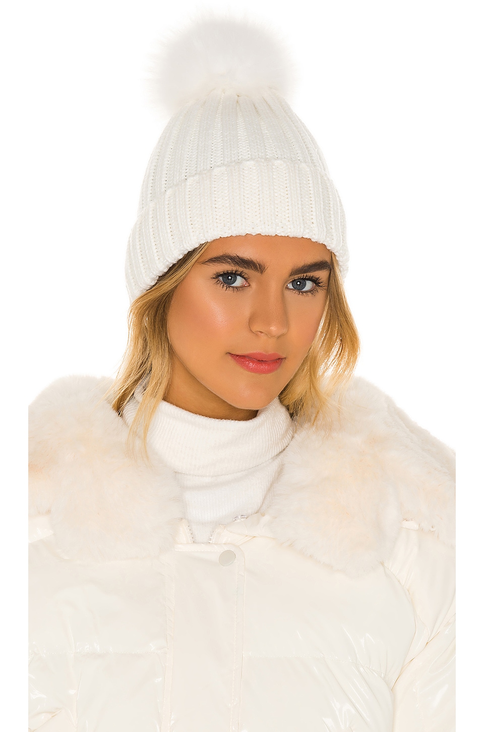 white hat with fur pom pom