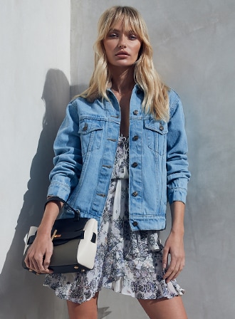 Model posing in a denim jacket.