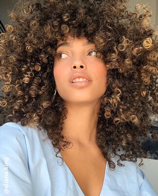 A close-up picture of Aliana King&rsquo;s curly hair. The Beauty Shop. Shop Now.