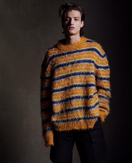 Model in a fuzzy orange and navy striped oversized Marni sweater.