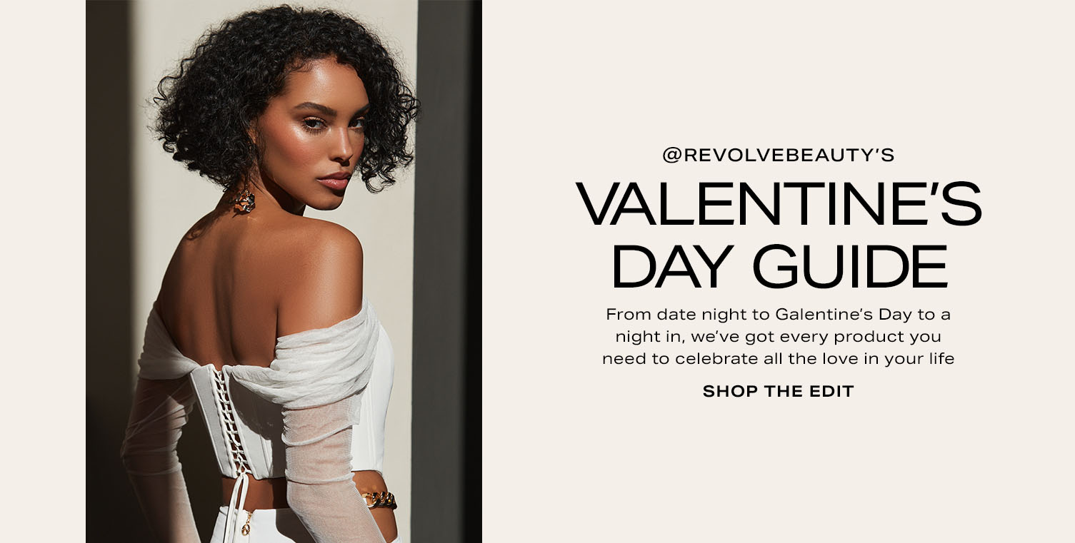 A model wearing an off-shoulder white top. Valentine’s Day Guide. Shop the Edit.