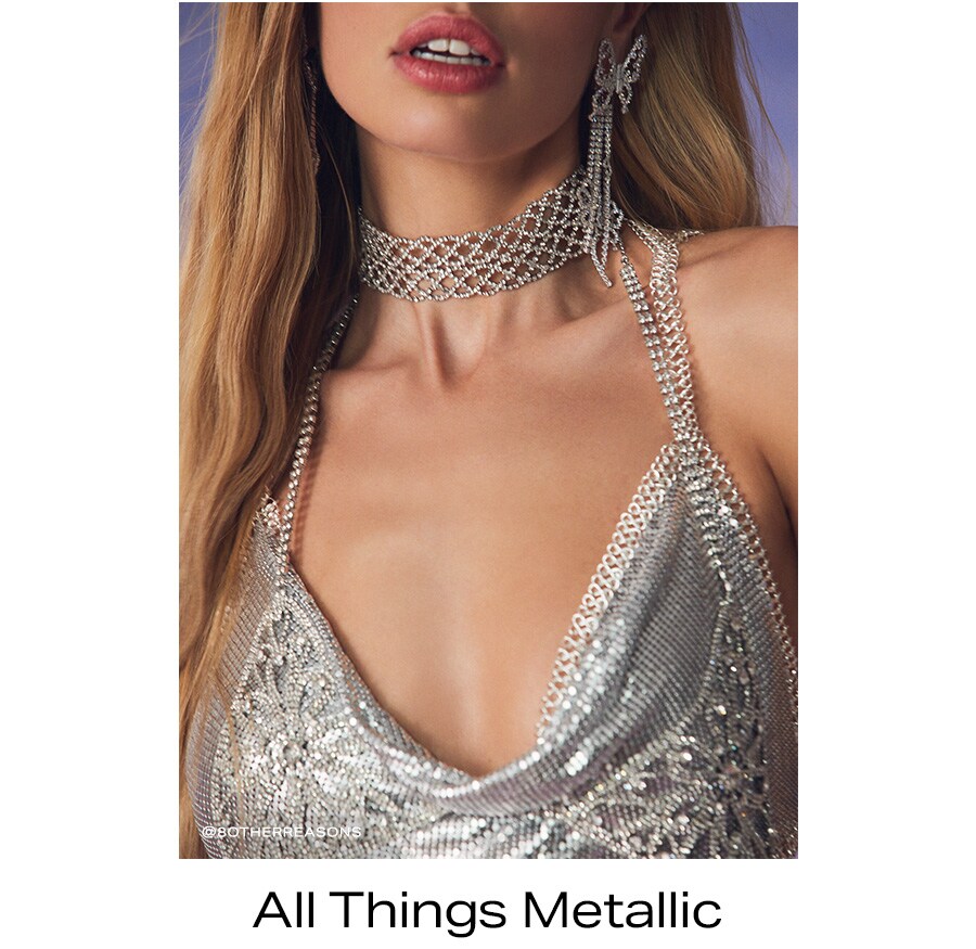 Model in silver and jewel studded mesh-style jewelry and halter top. All Things Metallic.