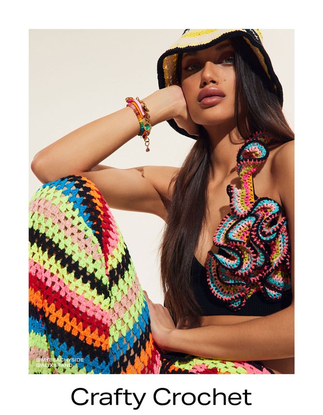 Model in bright multi-color crochet hat and dress.