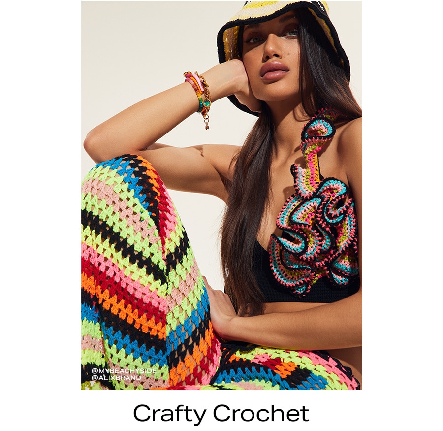 Model in bright multi-color crochet hat and dress. Crafty Crochet.