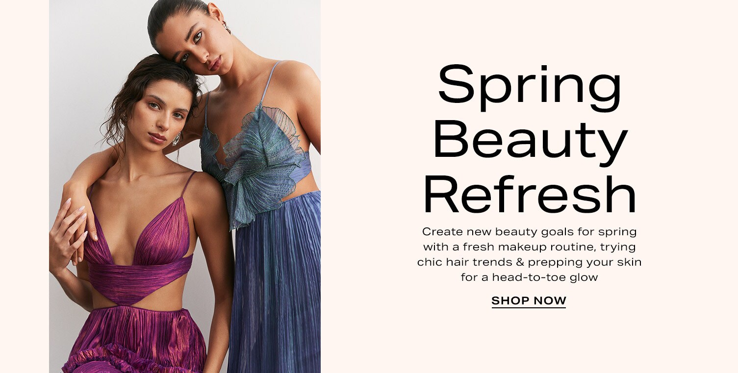 Left-most model wearing a purple and red plunging top with a matching colored ruffled skirt and the model on the right is wearing a similar outfit, but in blue. Spring Beauty Refresh. Shop Now.