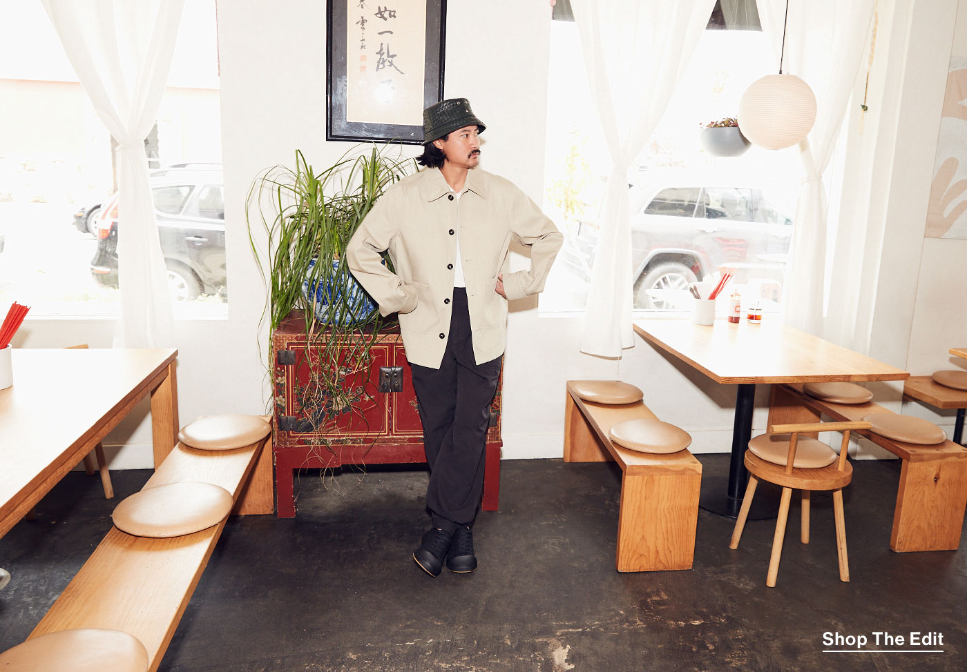 Keegan Fong standing in the dining area of his restaurant, Woon.
