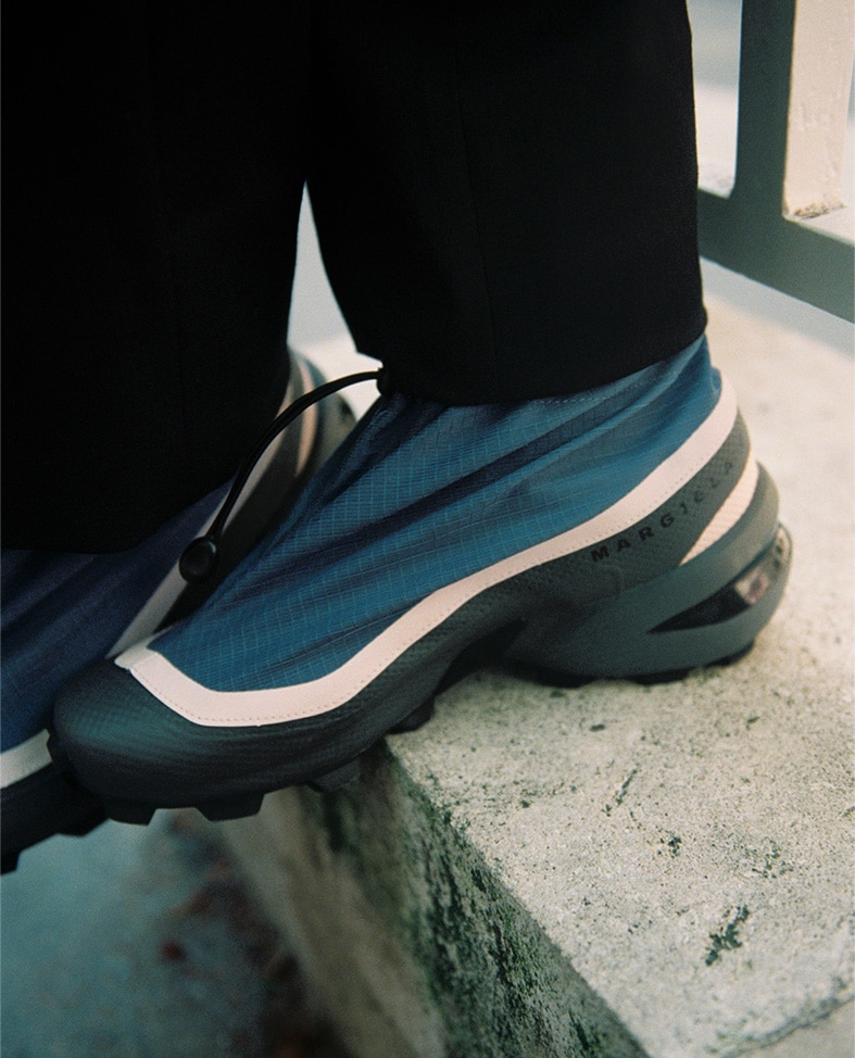 A close up of blue and white MM6 Margiela and Salomon sneaker.