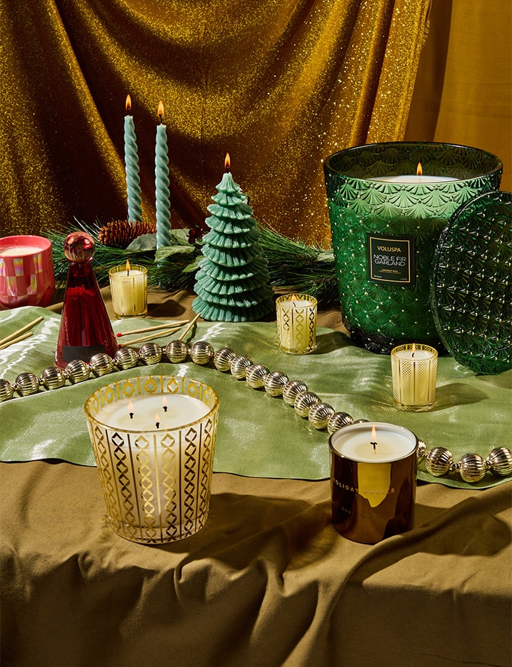 Green holiday candles and festive ornaments.