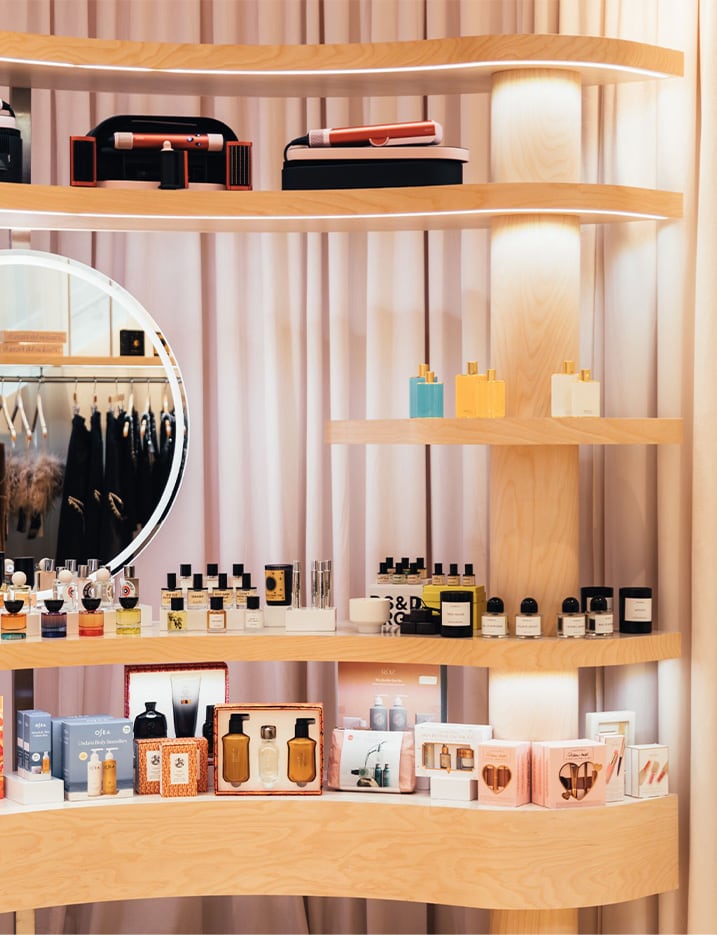 Shelves and clothing racks of products at The REVOLVE Holiday Shop at The Grove.