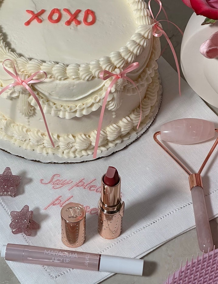 Beauty and skincare products displayed around a cake.