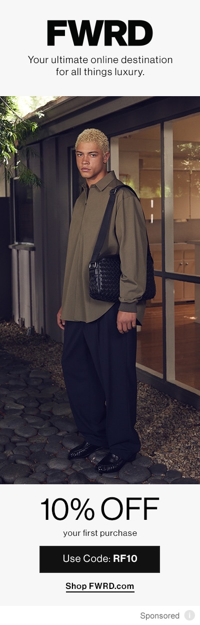 Man dressed in warm brown-green holding black bag