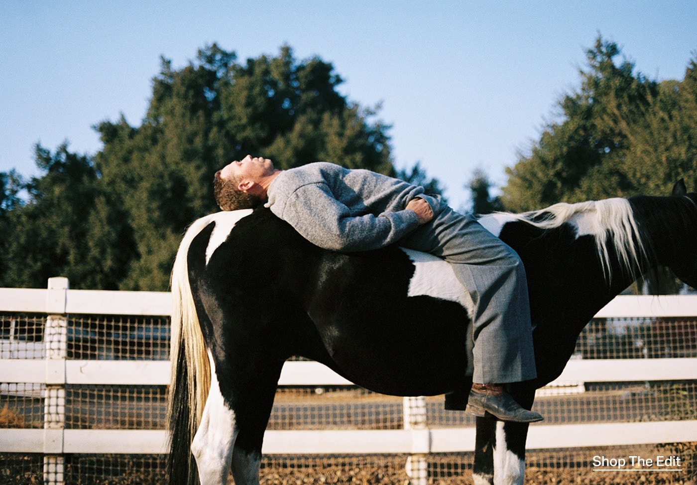 Nick Turner laying on a horse.