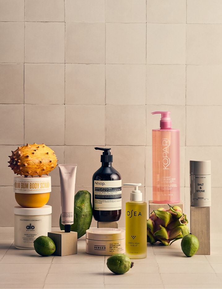 Variety of bath and body products alongside fruits.