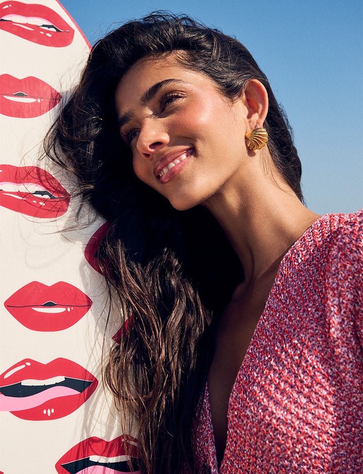 Model smiling at the beach.