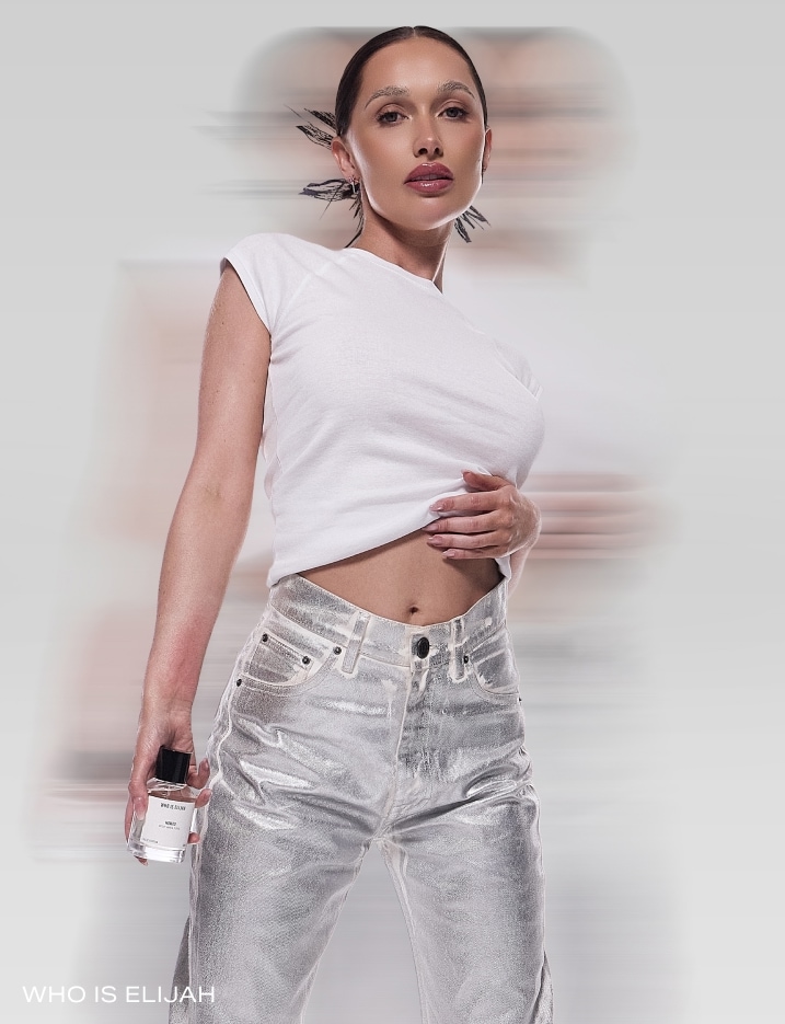 Model holding a bottle of Who Is Elijah perfume.