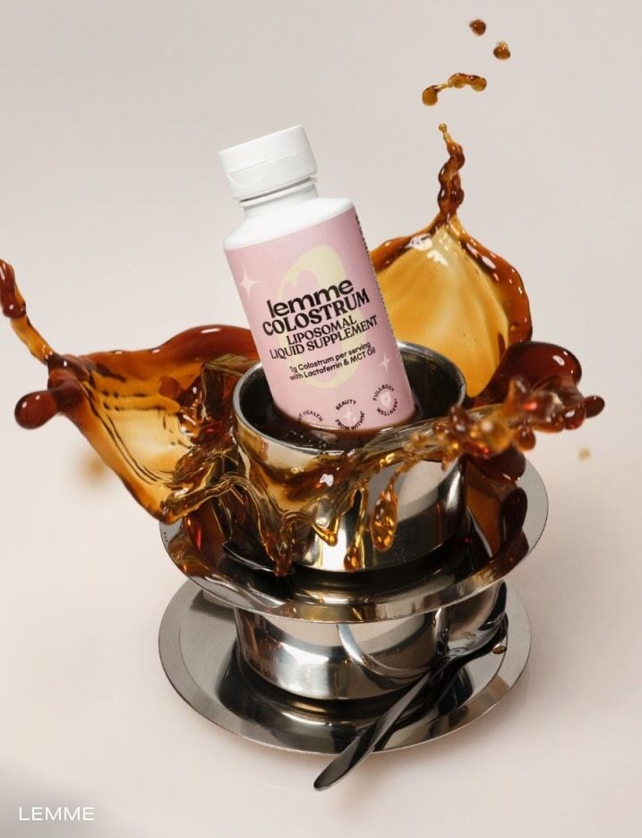 Lemme colostrum liposomal liquid supplement dunking into a cup of coffee.