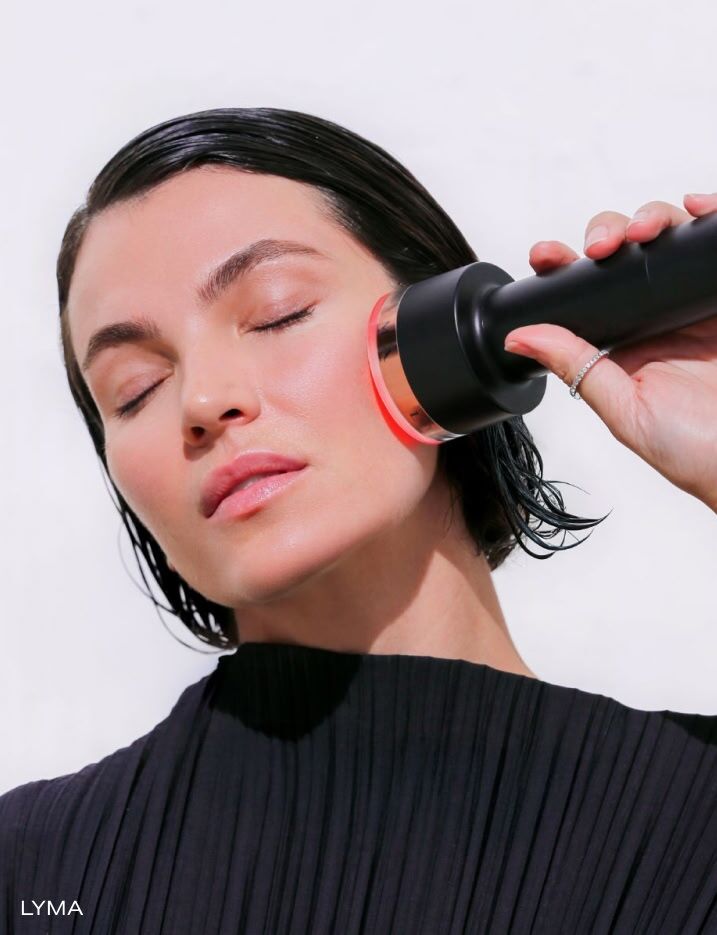 Model using the Lyma Laser Pro on her skin.