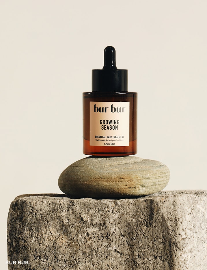 A bottle of bur bur Botanical Hair Treatment.