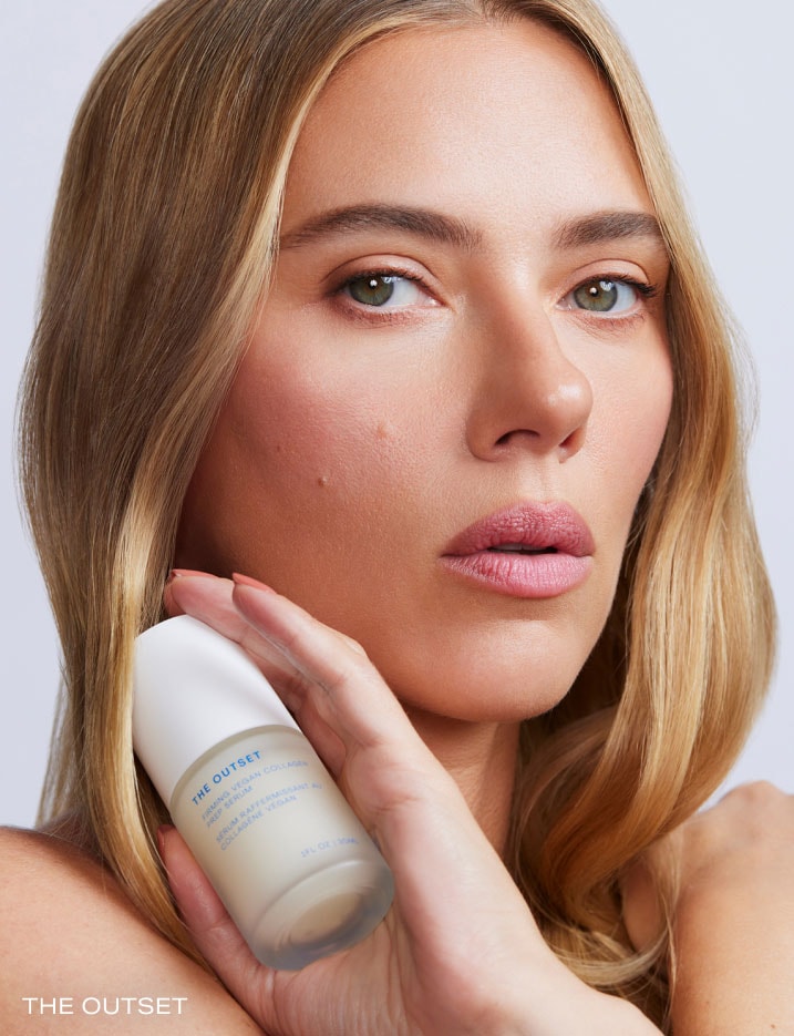 Modelholding a container of The Outset Firming Vegan Collagen Prep Serum.