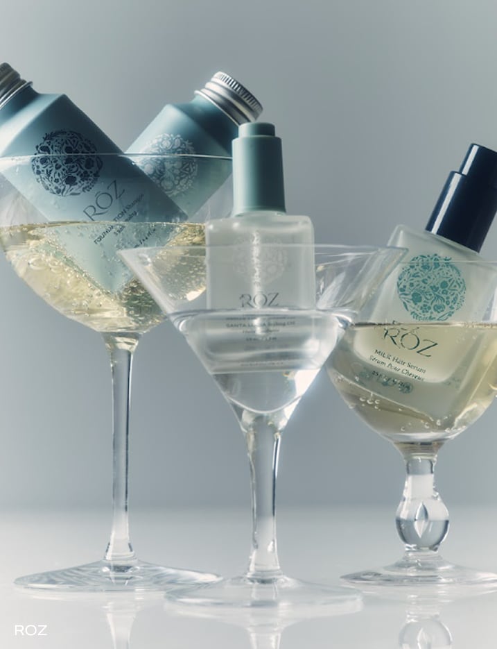 Variety of ROZ hair products in martini glasses.