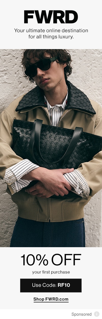 Model in brown Jacket Holding a Black Bag.