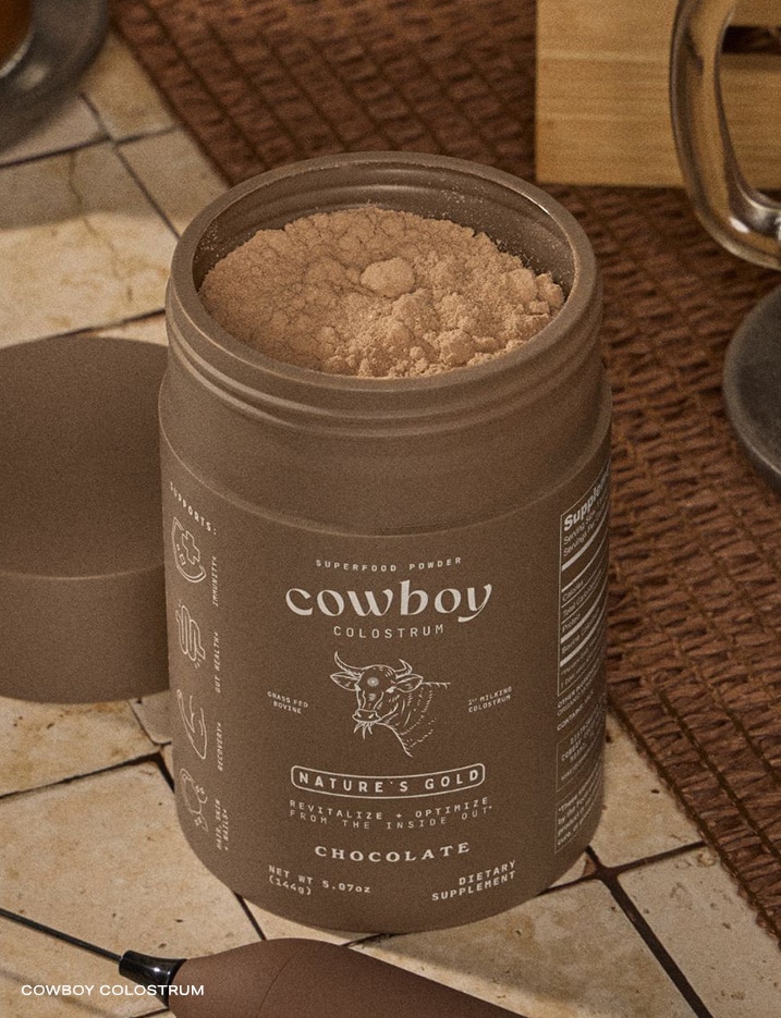 An open container of Cowboy Colustrum Nature's Gold: Chocolate Colostrum.