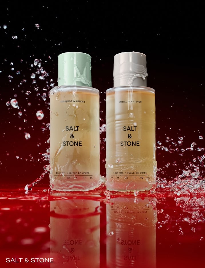 Salt & Stone Body Oils splashed in water.