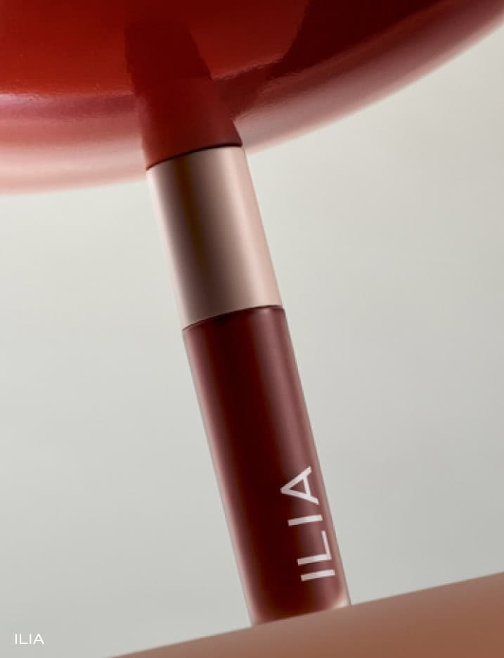 A container of Ilia Overglaze Hydrating Lip Gloss.