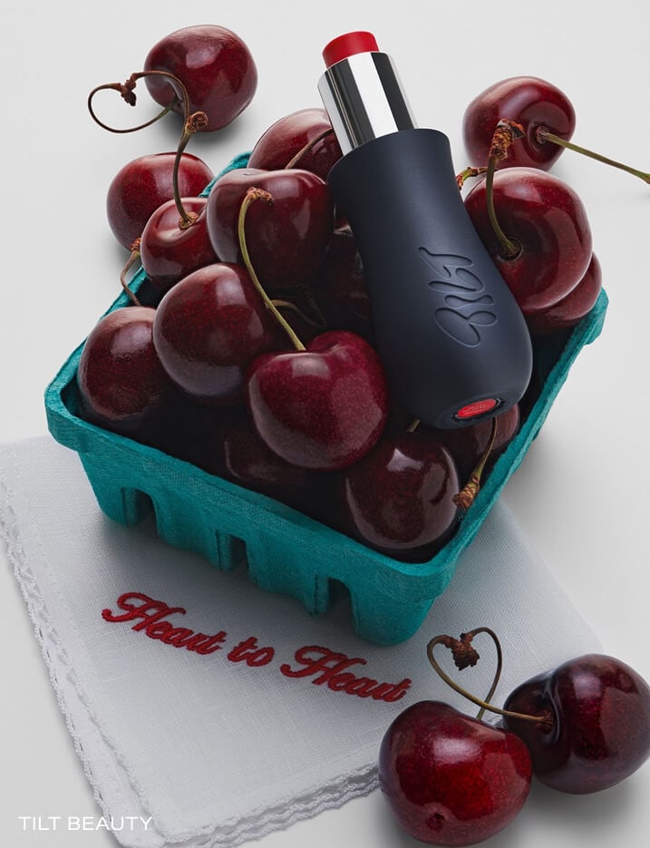 Tilt beauty lipstick in a basket of cherries.
