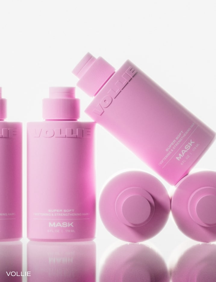 Pink bottles of Vollie hair masks.