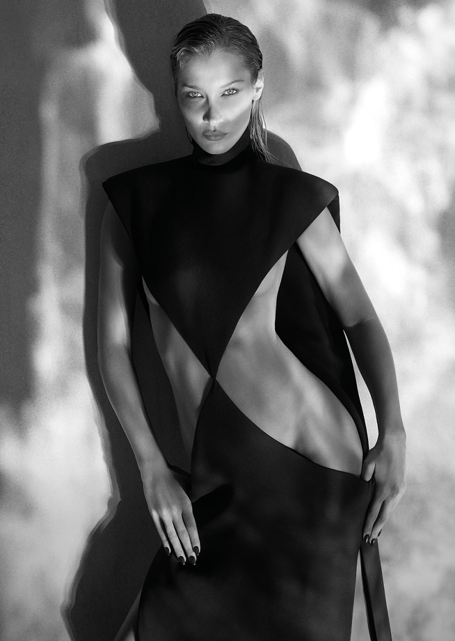 model bella hadid in black and white with heavy shadowding in a black gown with large side cutouts 