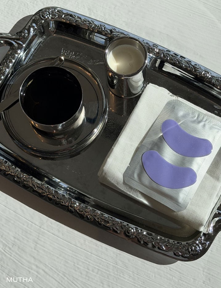 Mutha eye masks placed on a tray with coffee and creamer.