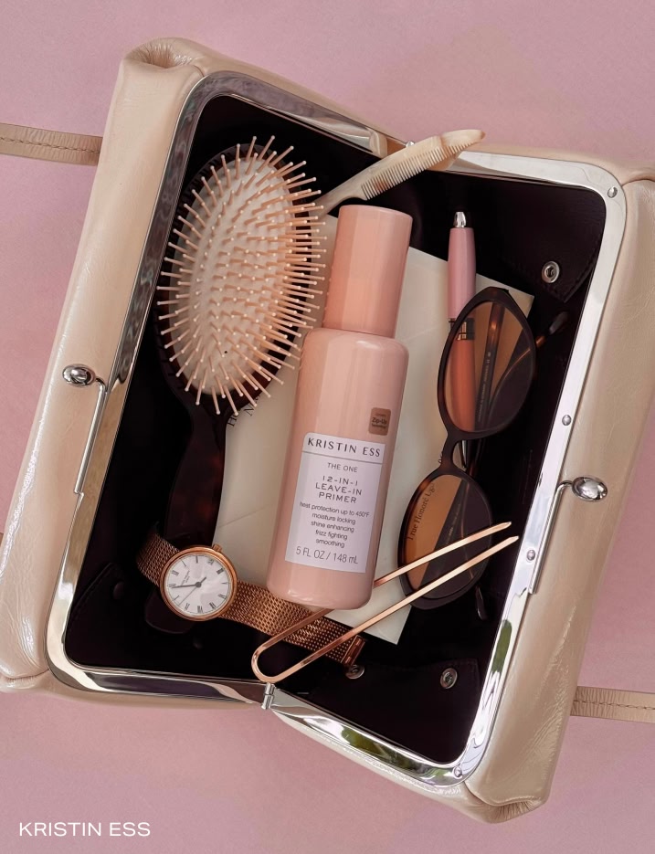 A bottle of Kristen Ess haircare in a travel bag.